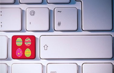 Easter eggs against red Apple key on keyboard