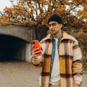 Man met iPhone in oranje hoesje