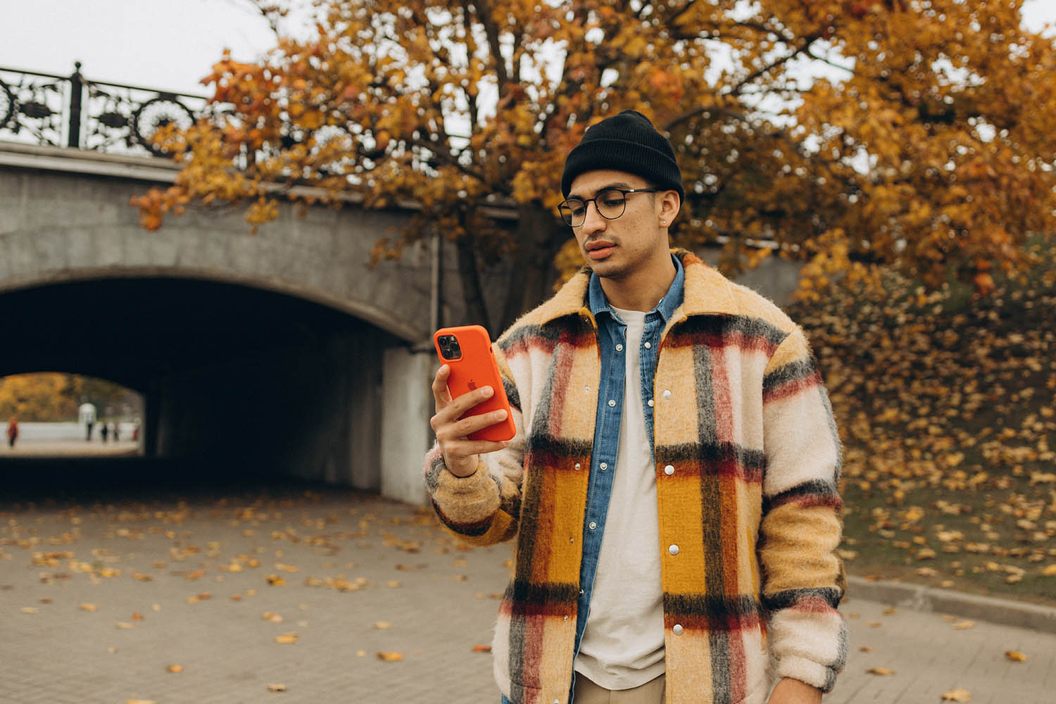 Man met iPhone in oranje hoesje